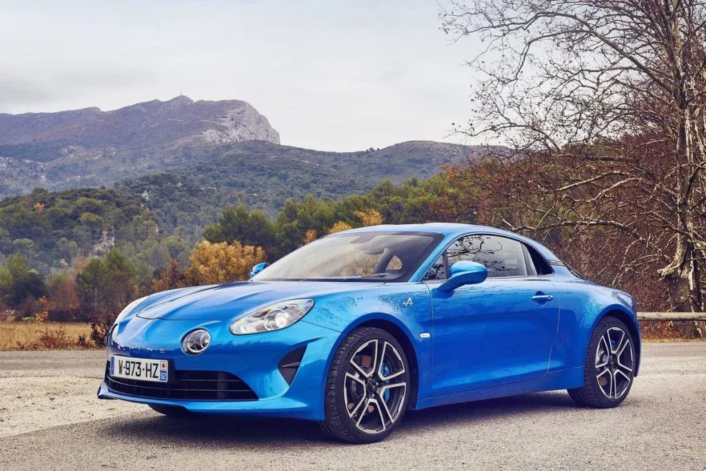 Low blue Alpine A110 coupé as a design study in a studio, with wide fenders and slim LED lights