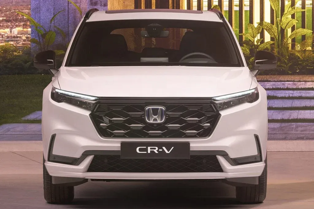 Honda CR-V Hybrid on a North American road in front of a modern suburban backdrop
