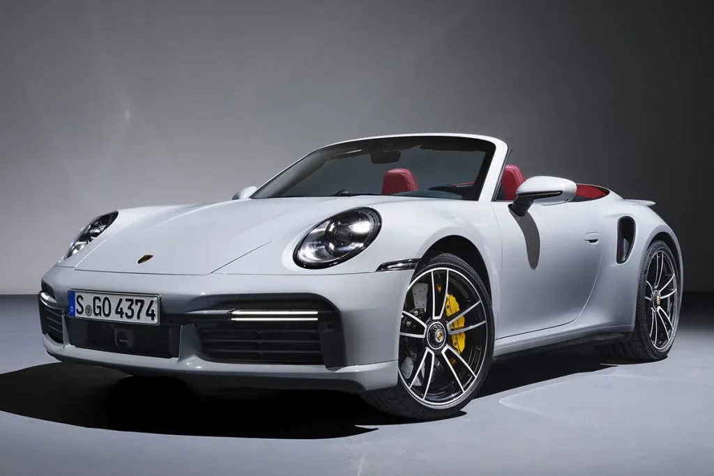 Porsche 911 Challenge as a low-slung race car on a racetrack in dynamic cornering