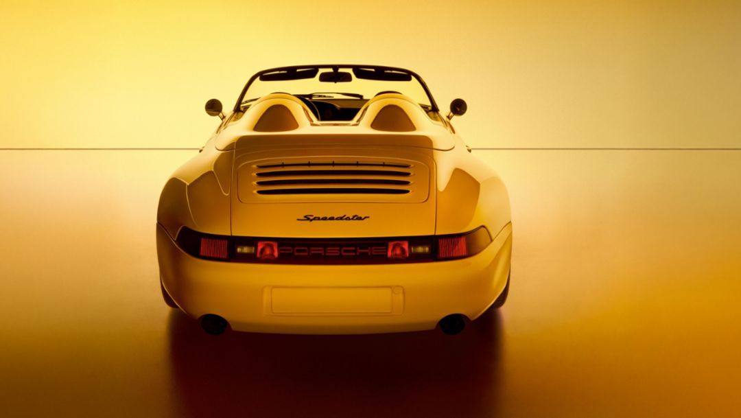 Darkly staged Porsche supercar study with a low front end, wide fenders, and mid-engine proportions