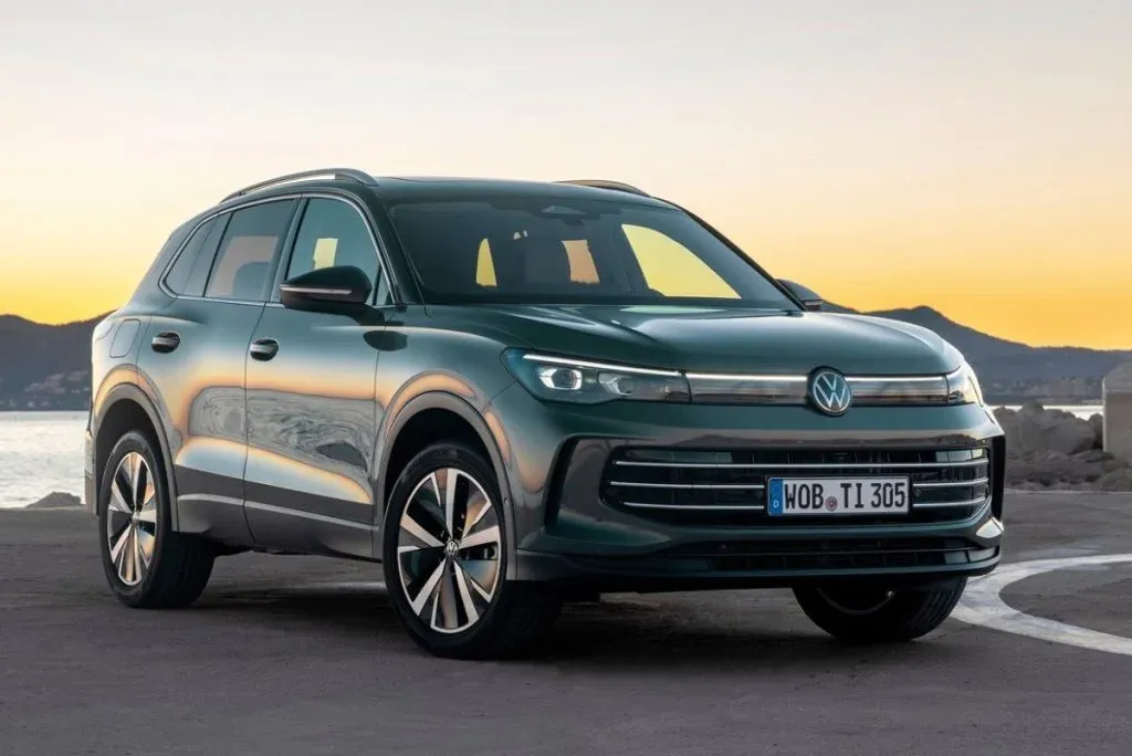Volkswagen Tiguan, Volkswagen Atlas and Audi Q3 as SUV models on a road in front of a neutral background